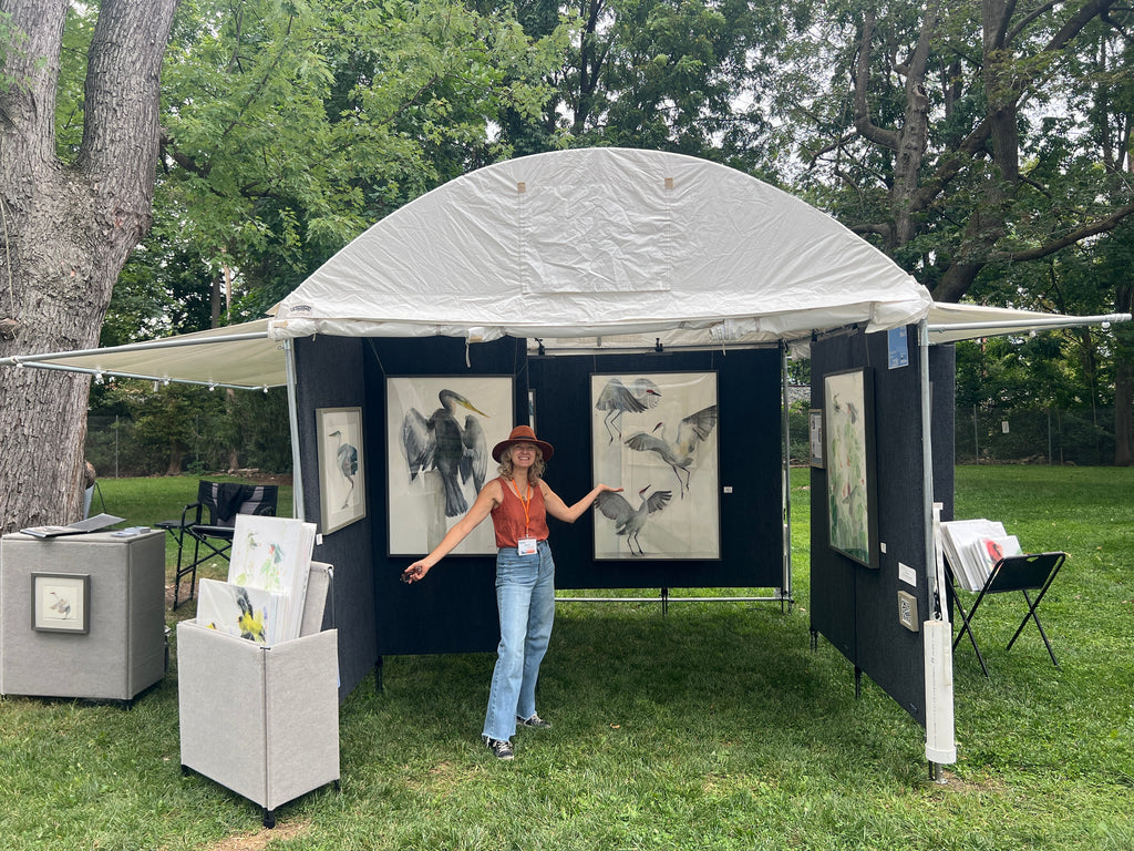 Holly Wach showcases artwork at Temple Bethel Artisan Fest featuring original bird watercolor paintings and prints.