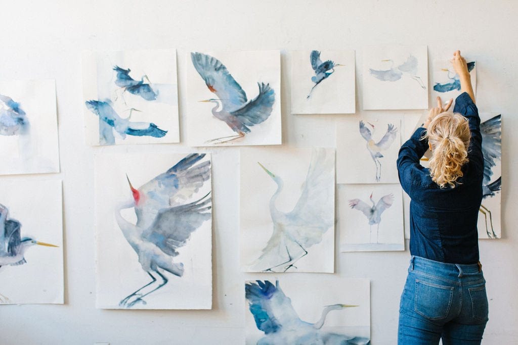 Holly Wach’s original art studio with a wall displaying bird watercolor art paintings