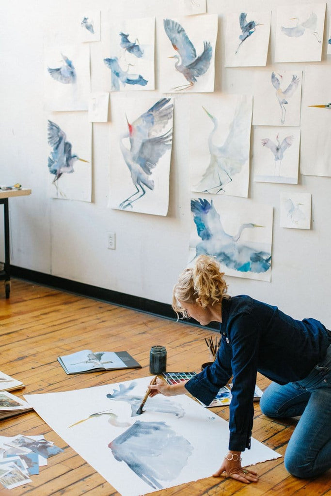 Holly Wach (artist) painting an original watercolor on the floor