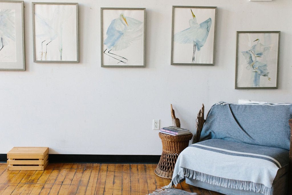 Holly Wach’s original art studio with a wall displaying bird watercolor art paintings