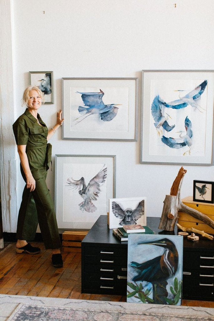 Holly Wach’s original art studio with a wall displaying bird watercolor art paintings