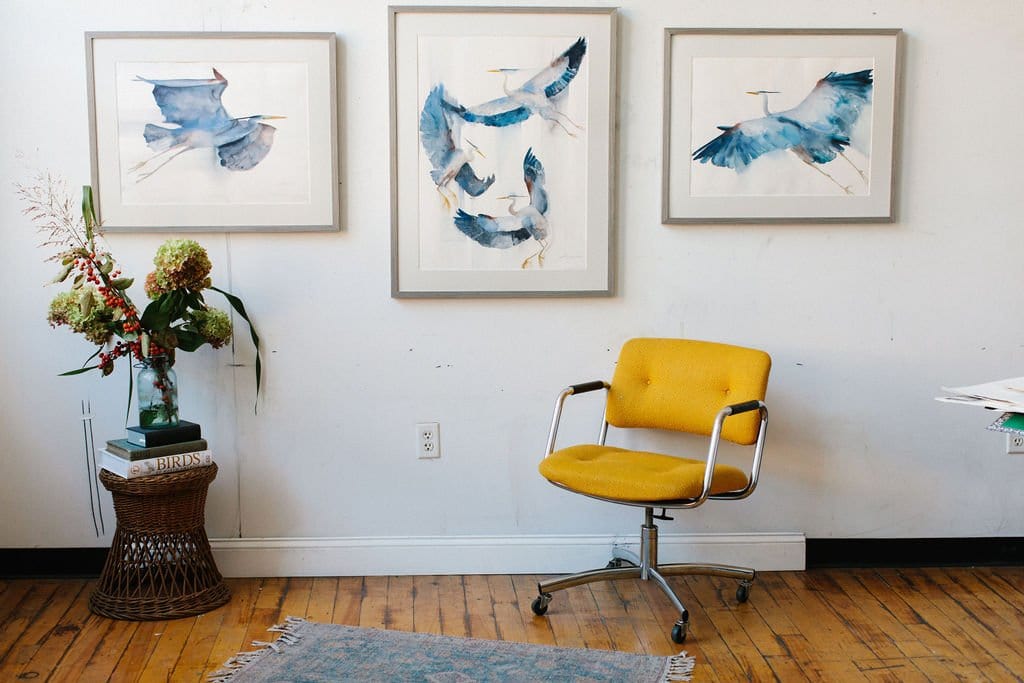 Holly Wach's art studio with bird watercolor art paintings on a wall