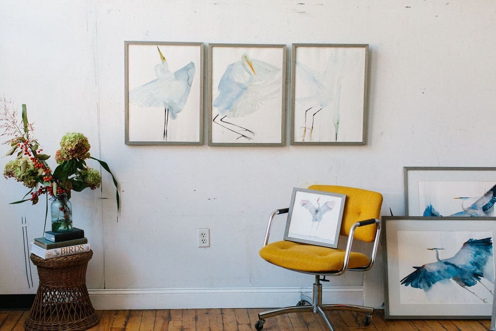 Holly Wach’s original art studio with a wall displaying bird watercolor art paintings